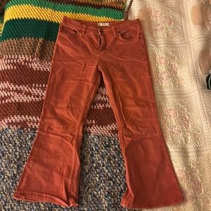 Free people rust colored mid to low rise boot cut jeans